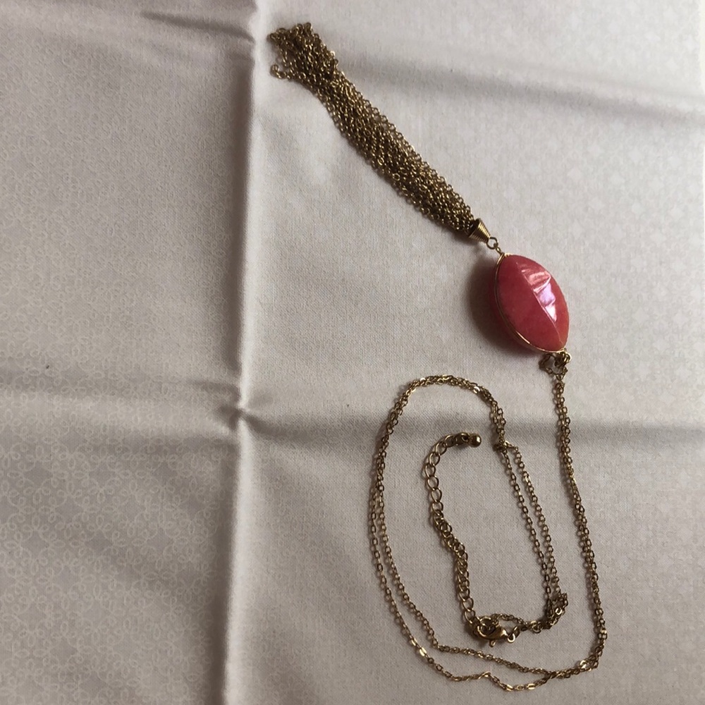 Gold necklace with pink pendant and gold tassel
